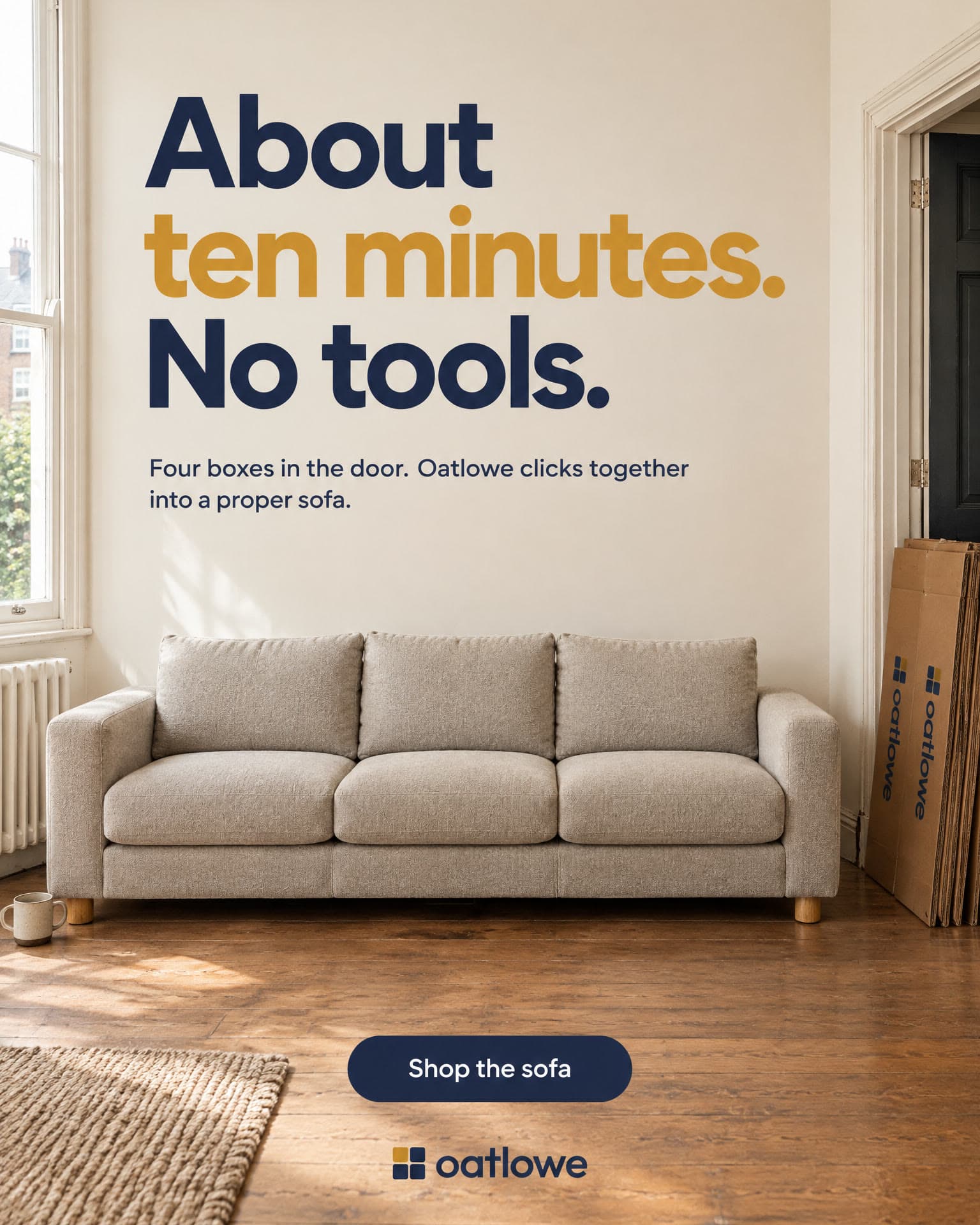The Oatlowe sofa in a bright, empty room, its flattened boxes leaning by the door. It reads: About ten minutes. No tools. Four boxes in the door. Oatlowe clicks together into a proper sofa. Shop the sofa.